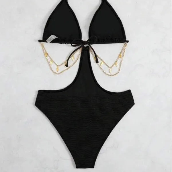 Women's black bikini swimsuit with decorative chain detail on a mannequin.
