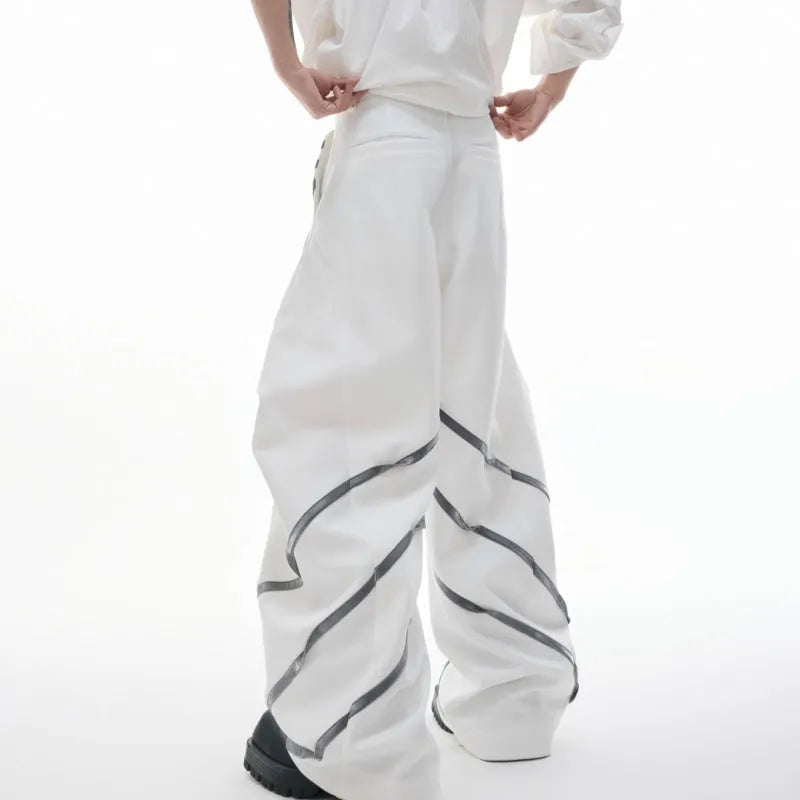 Men's black polyester trousers with metal rivet stripe and front pleats on a white background.
