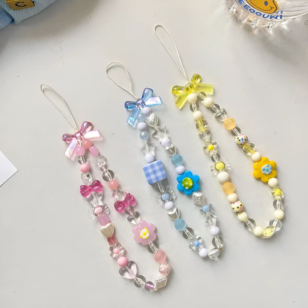 Yellow beaded flower mobile phone lanyard with plastic resin beads on a white background.
