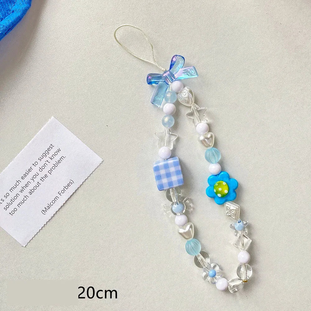 Yellow beaded flower mobile phone lanyard with plastic resin beads on a white background.