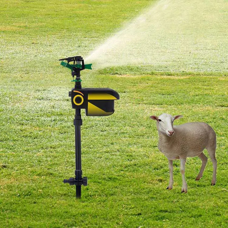 Black automatic PIR animal repellent garden sprinkler made of ABS plastic with rotating nozzle on grass