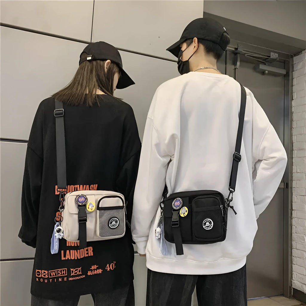 Casual nylon messenger bag for men and women, 22 x 6 x 17 cm, in black milky white grey or blue with two badge pendants