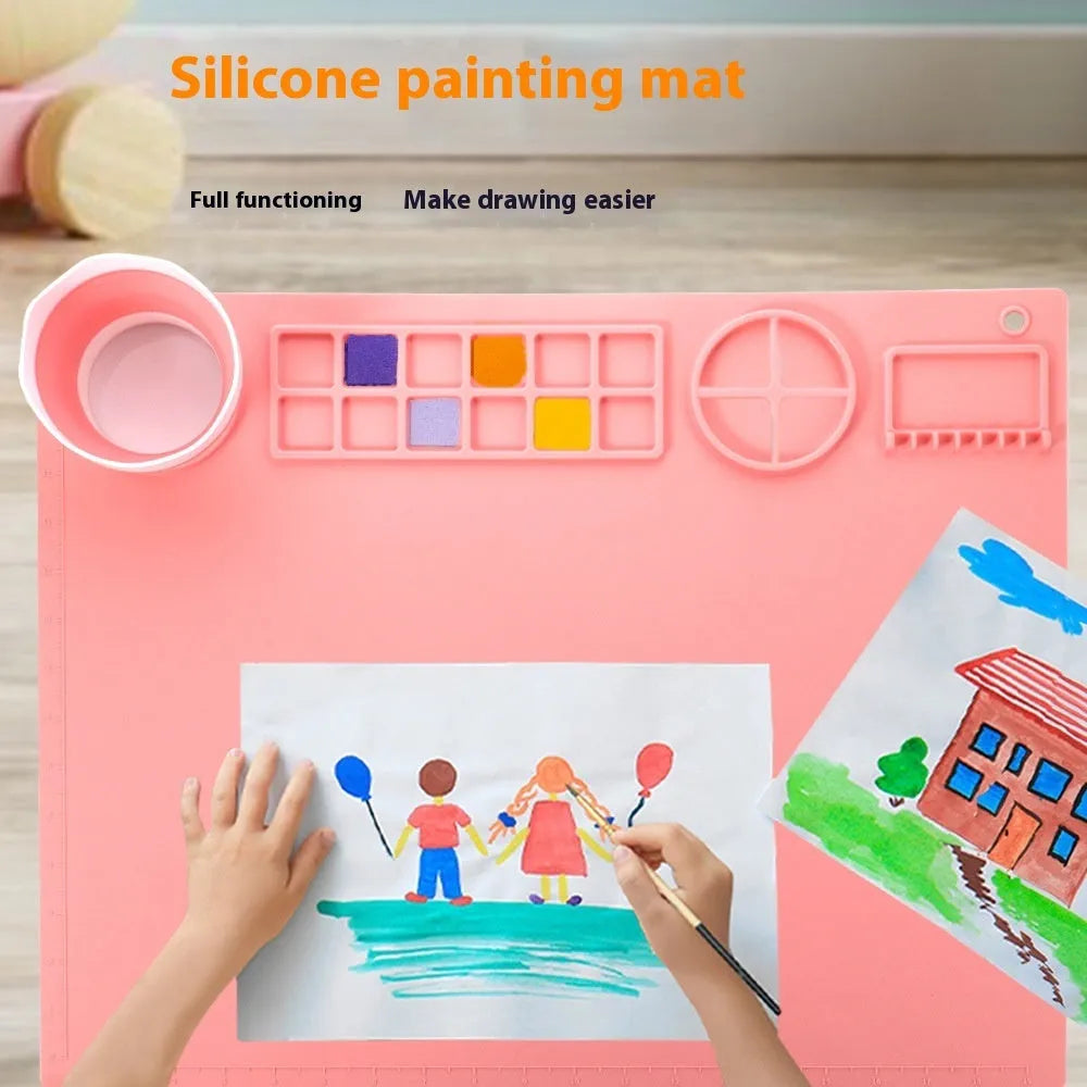 Light blue silicone painting mat measuring 50x40cm with two raised mixing bowls on its surface.