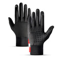 Pair of black winter outdoor sports gloves with touchscreen fingertips on a neutral background