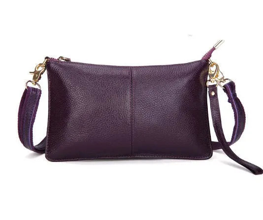 A cowhide lady slant bag in a chosen colour, showing hand and shoulder straps, with dimensions of 24 cm by 14 cm.