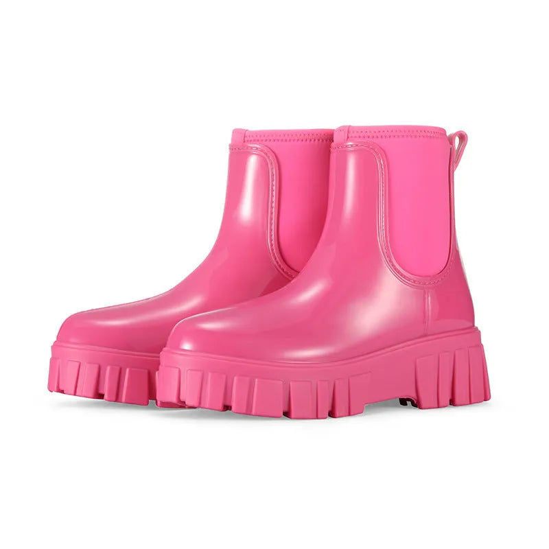 A pair of low tube, flat-heeled PVC rain boots in a solid colour.