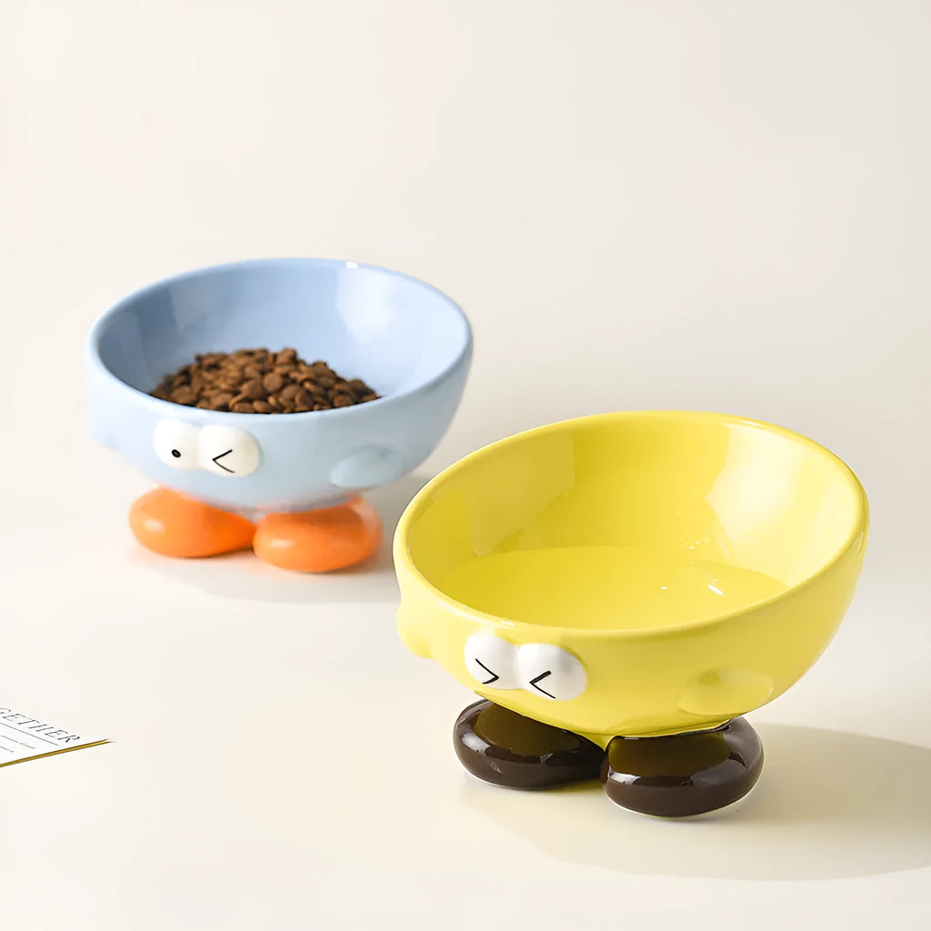 Ceramic pet bowl with oblique design and cute expressions for cervical spine protection