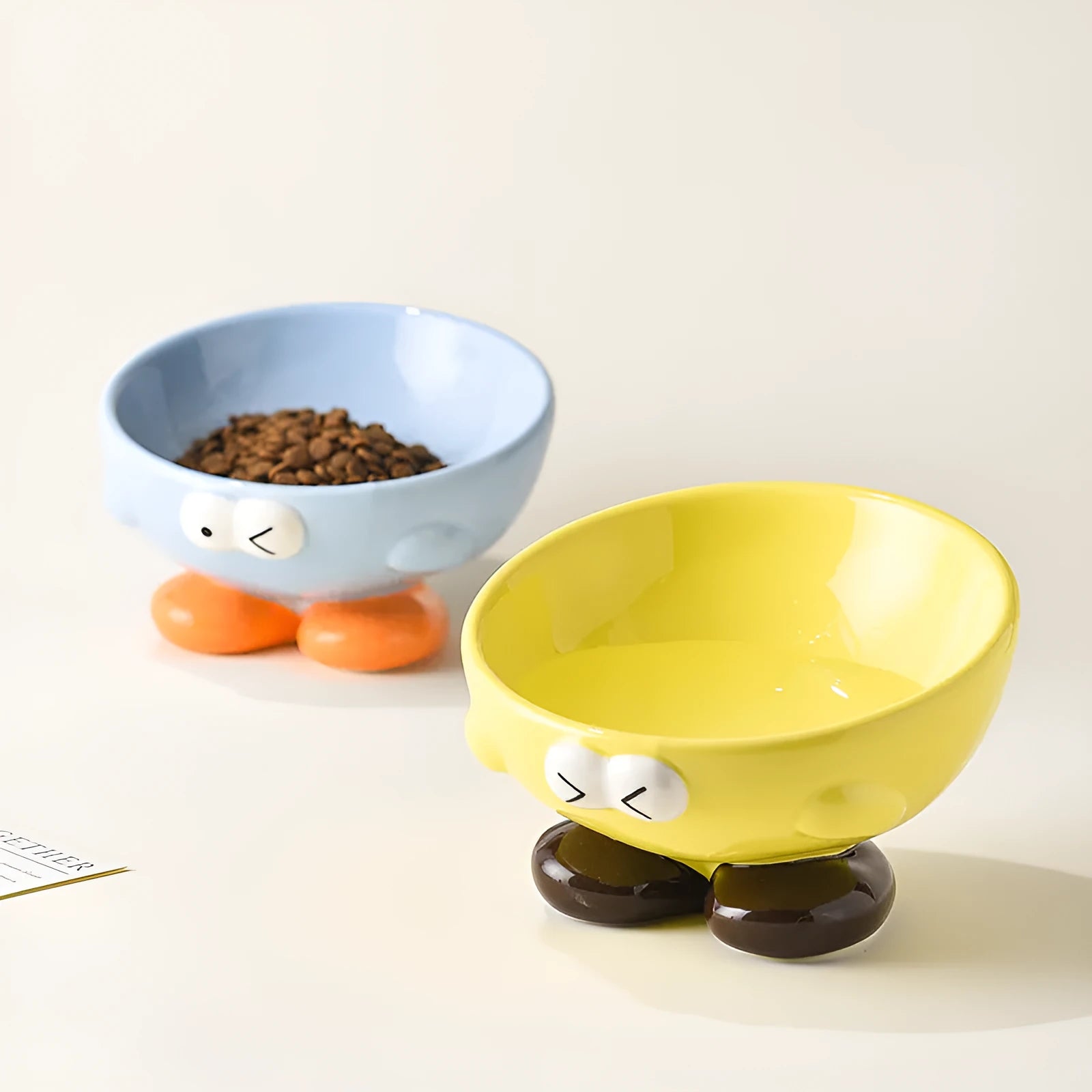 Ceramic pet bowl with oblique design and cute expressions for cervical spine protection
