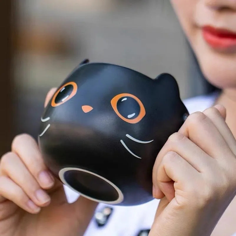 Black ceramic cat-shaped mug with pumpkin decoration and optional spoon lid, 355ml capacity.