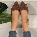 Women's blue knitted flat loafers with a pointed toe and a decorative bow on the front