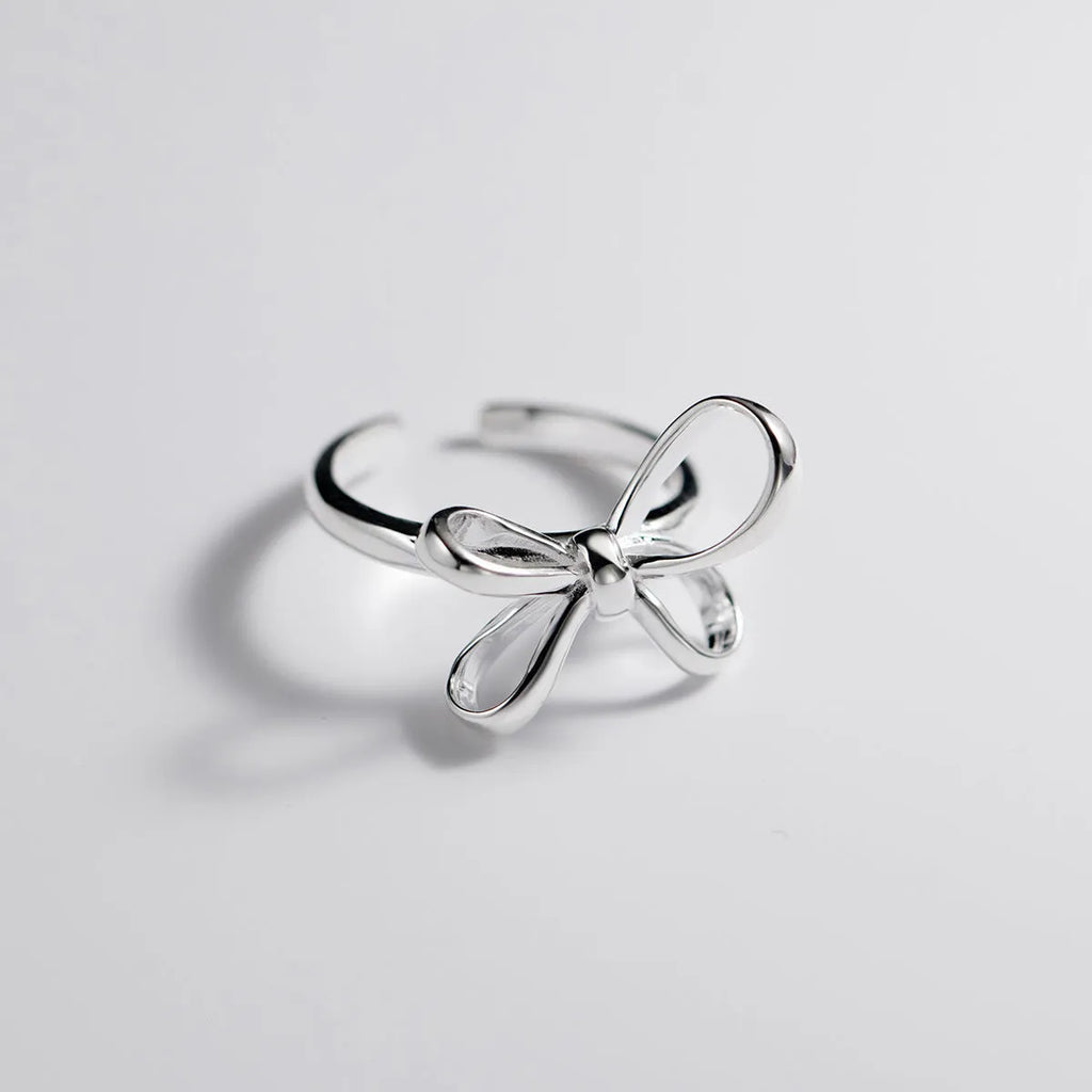 S925 silver bow ring with adjustable open band on hand, showing polished finish and Korean style design