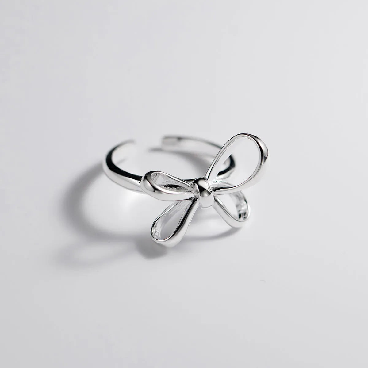 S925 silver bow ring with adjustable open band on hand, showing polished finish and Korean style design