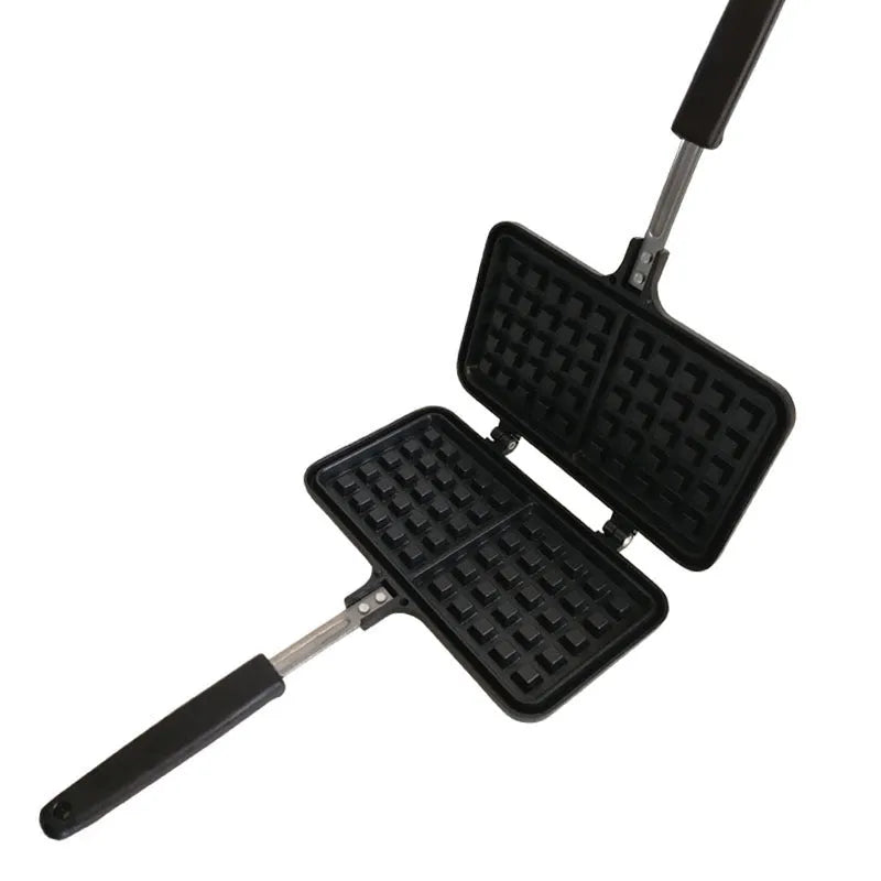 Black aluminium alloy waffle cake mold with nonstick plates and locking handle on gas stove