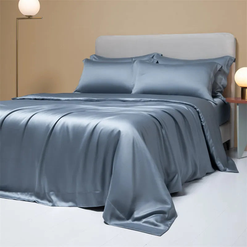 Aurora Blue 200 thread count Tencel duvet cover, fitted sheet, and pillowcases laid on a modern bed.