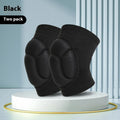 A pair of black thick sponge kneepads made from polyester fabric, shown on a knee.