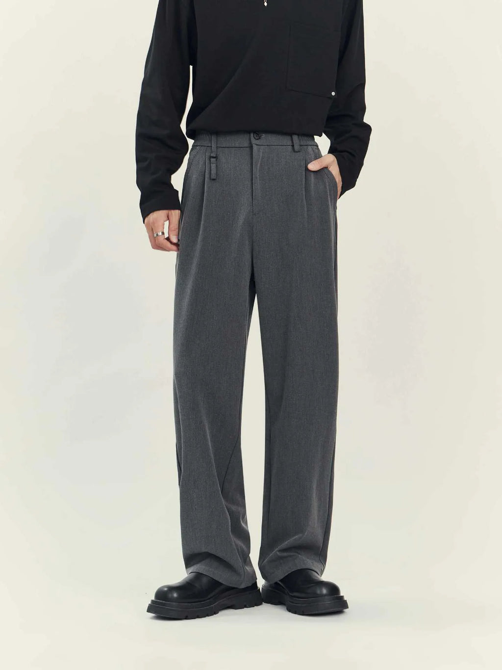 Black and grey loose straight-leg business casual trousers on a hanger, showing draping fit.