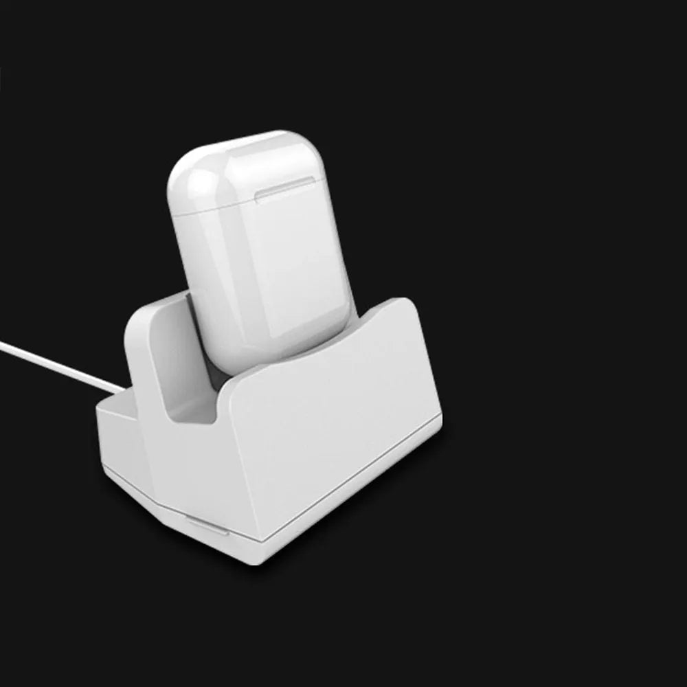 White minimalist headphone charging base on a desk or table