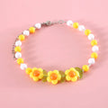 Colourful plastic bead pet necklace shown in peach, rainbow, and small flower patterns with an adjustable clasp.