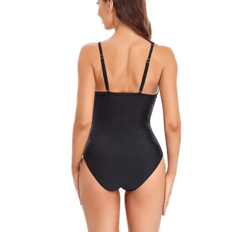 Ladies' solid colour black backless one-piece swimsuit laid flat, showing mesh design and high-cut legs.