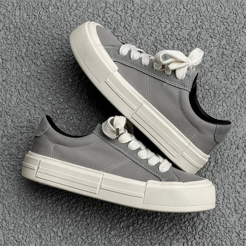 Canvas platform casual skate shoes with lace-up, tassel detail, and rubber sole in black and gray