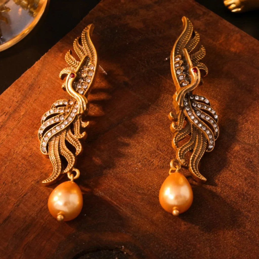 Pair of phoenix drop earrings in gold-tone electroplated alloy, hollow jeweled distressed design, 7cm by 1.6cm.
