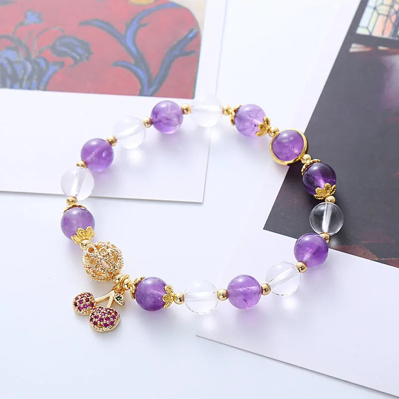 Close-up of a women's purple crystal bracelet with a micro-inlaid cherry flower design on an adjustable band.