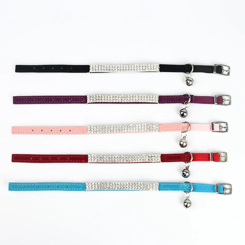 Red velvet cat collar with a line of sparkling rhinestones, showing the adjustable buckle.
