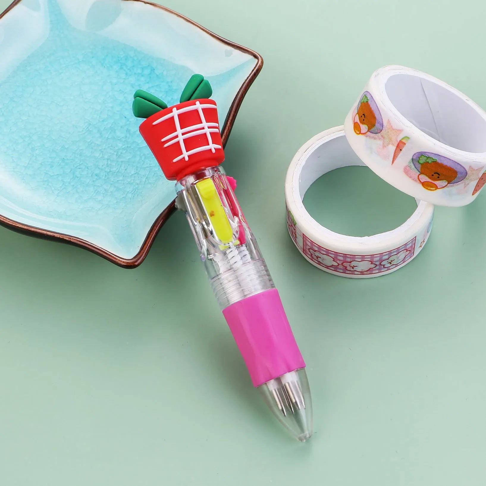 Compact 11cm Christmas ballpoint pen with four colours and festive designs like snowmen and reindeer.