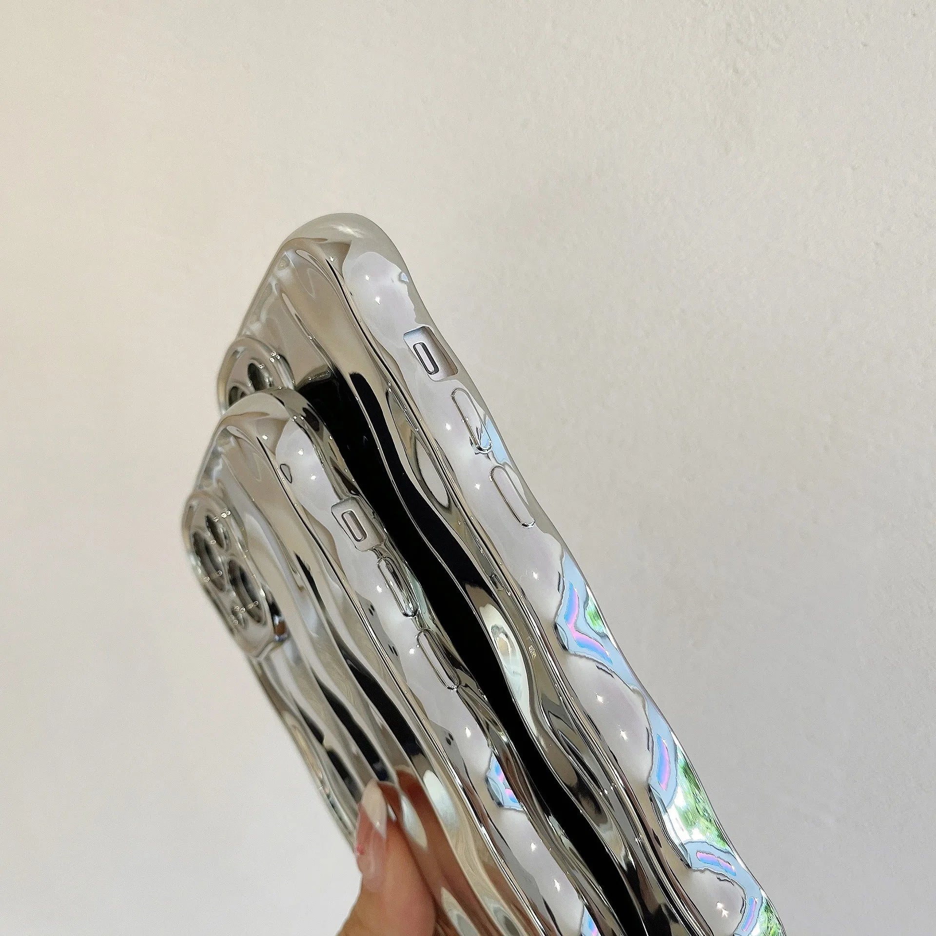 iPhone 17 Pro Max phone case with electroplated silver wave stripe design on black TPU back cover.