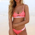 Women's black and white polka dot and red and white stripe polyester bikini set for swimming.