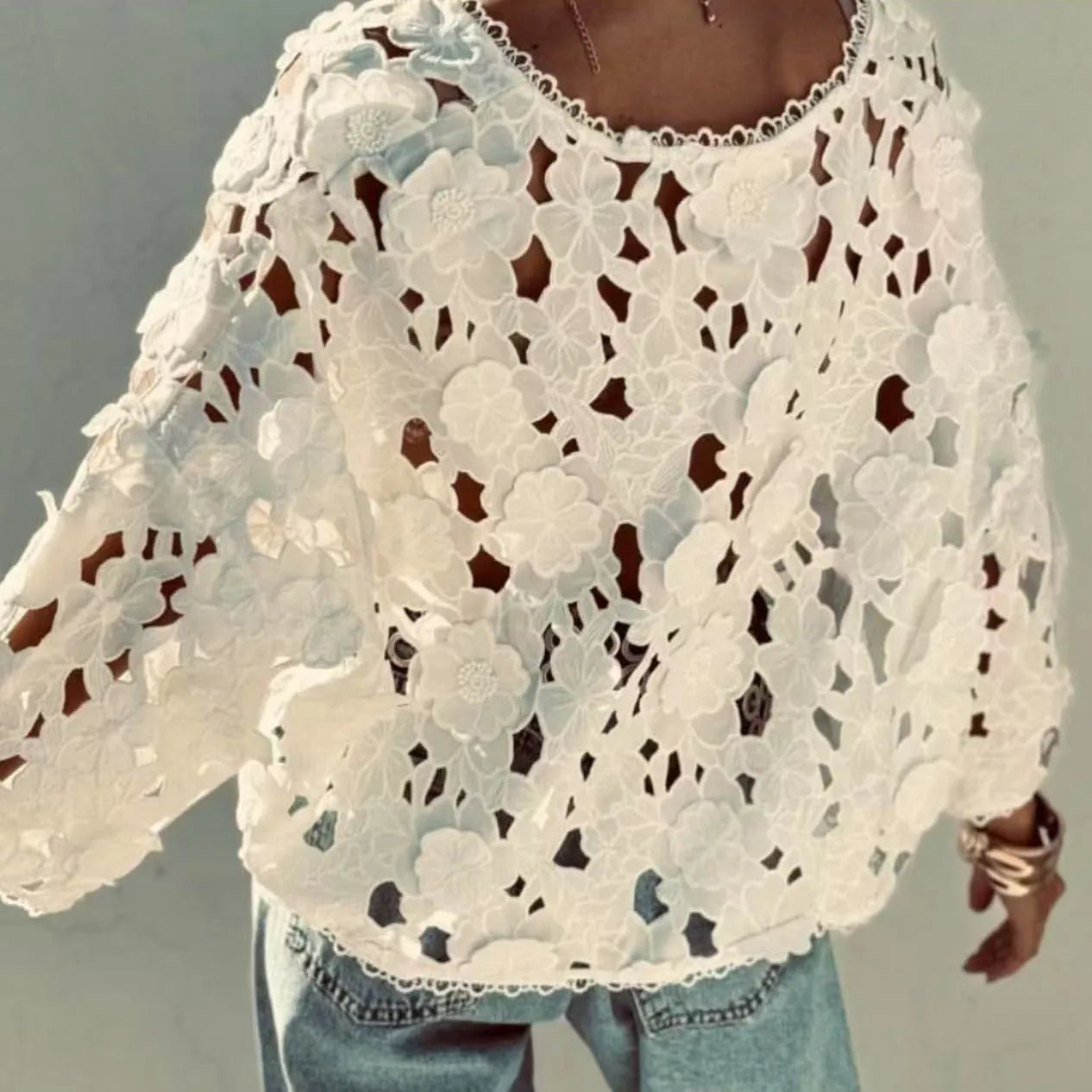 A women's loose black lace cardigan with a V-neck and three-dimensional floral decoration on the front.