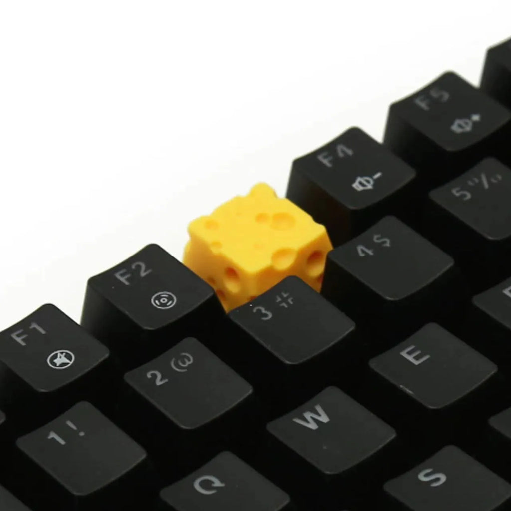Yellow solid resin artisan key cap sculpted like a piece of cheese for mechanical keyboards.