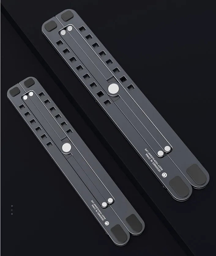 Silver foldable aluminium laptop stand holding a MacBook at an adjusted angle