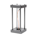 Metallic gray acrylic square night lamp with curved wire on a desk
