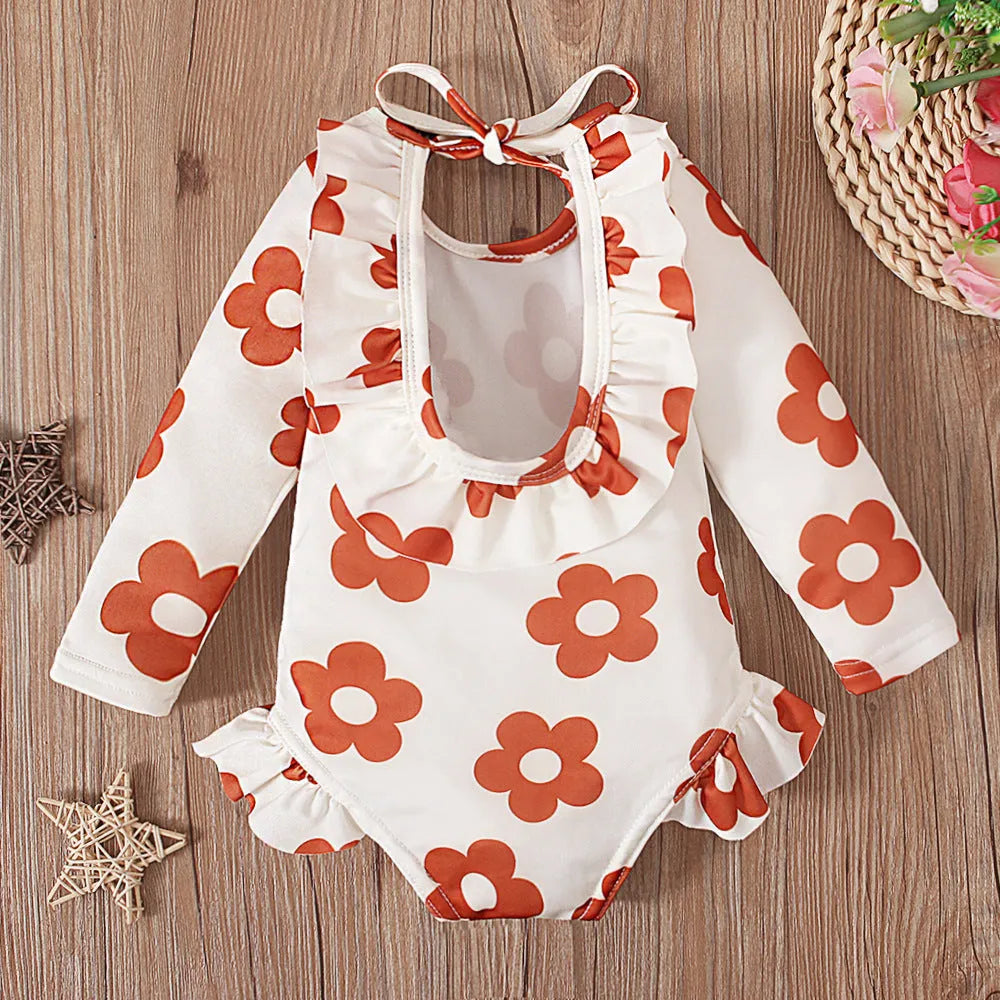 Girl's white floral print one-piece swimsuit with crew neck and open back design