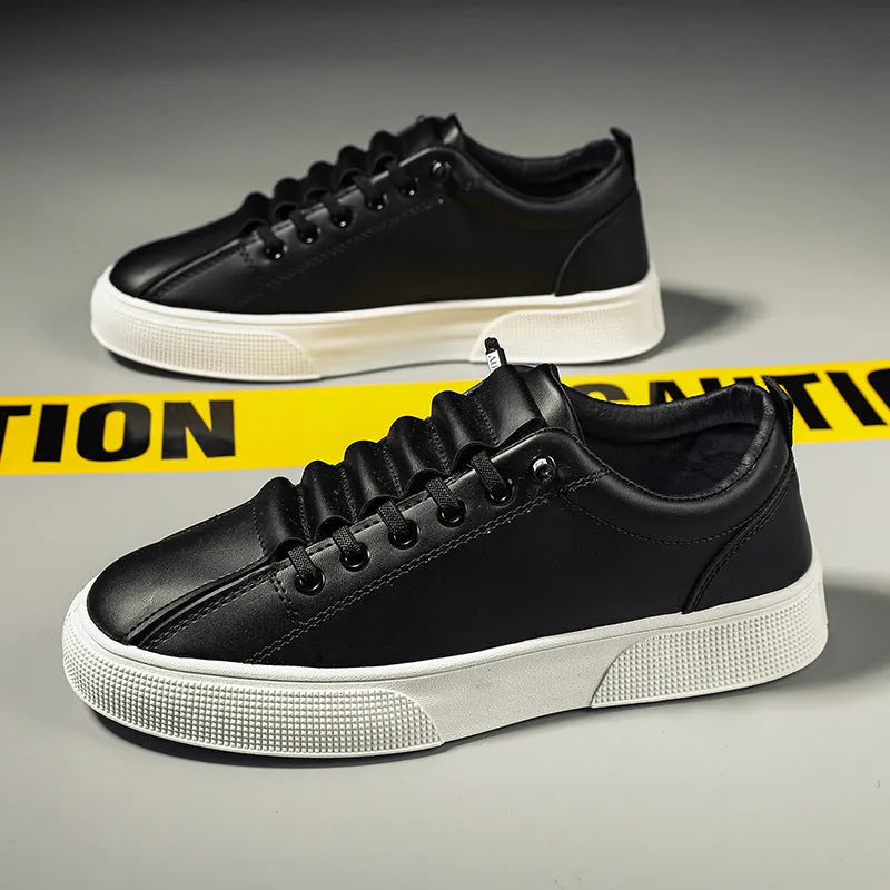 Men's black and white low top sports shoes with mesh panels and synthetic leather upper on a flat PVC sole.