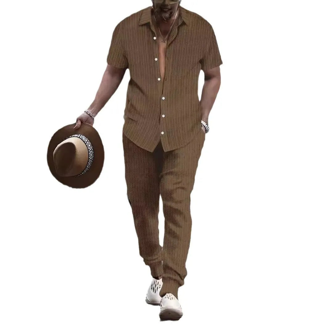 Man wearing a casual short-sleeve shirt and trousers beach suit set in a light blue colour.