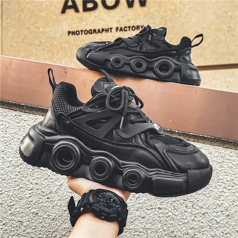 Men's low-top casual sneakers in black with a mesh upper, thick rubber sole, and round toe.