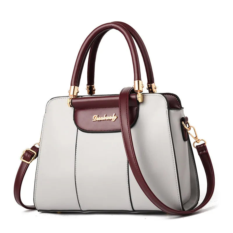 Large PU ladies handbag with zip top, soft handle, and stitching detail, shown in beige.