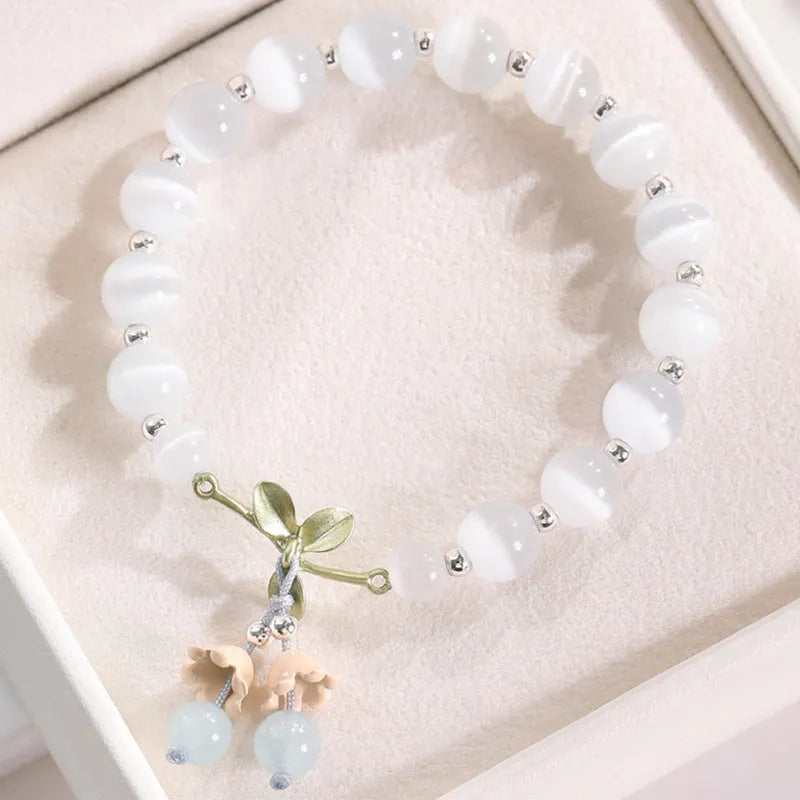 Close-up of electroplated opal cat's eye beaded bracelet for women with diamond-shaped charm