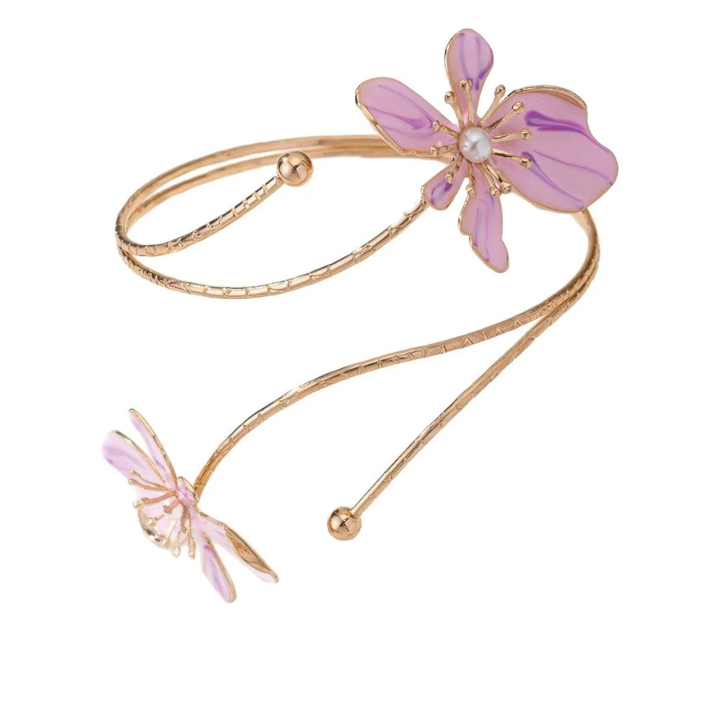 Close-up of a pink adjustable alloy armband with a hollow line pattern on a wrist.