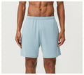 Man wearing sky blue double-layer quick-drying running shorts with a mid-waist fit.