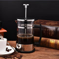 Compact stovetop espresso maker with glass upper section and stainless steel base