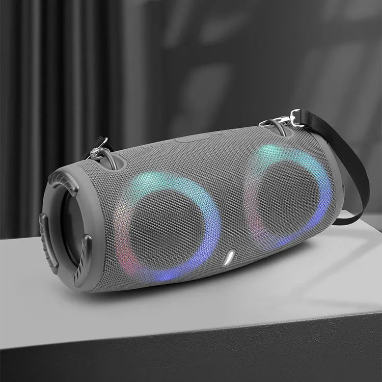 Cylindrical War Drum Bluetooth speaker with coloured RGB lights in a waterproof outdoor setting.
