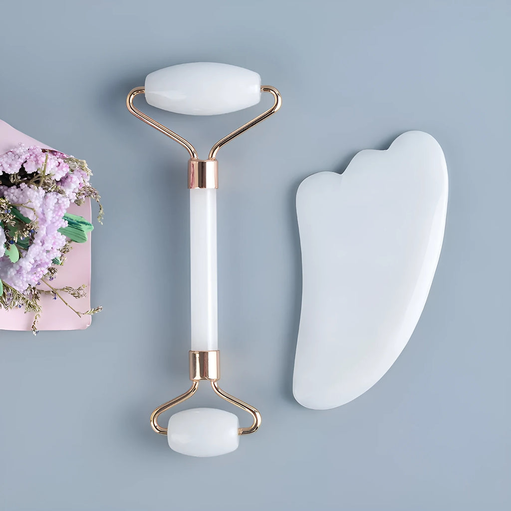 White jade double-headed facial roller and gua sha scraping tool set on a storage board.