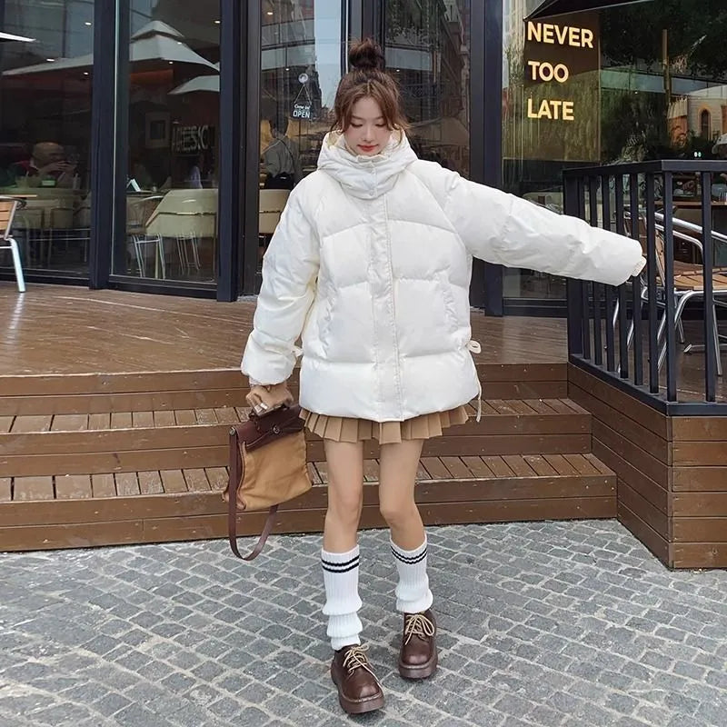 Women's loose black winter jacket with princess sleeves on a hanger.