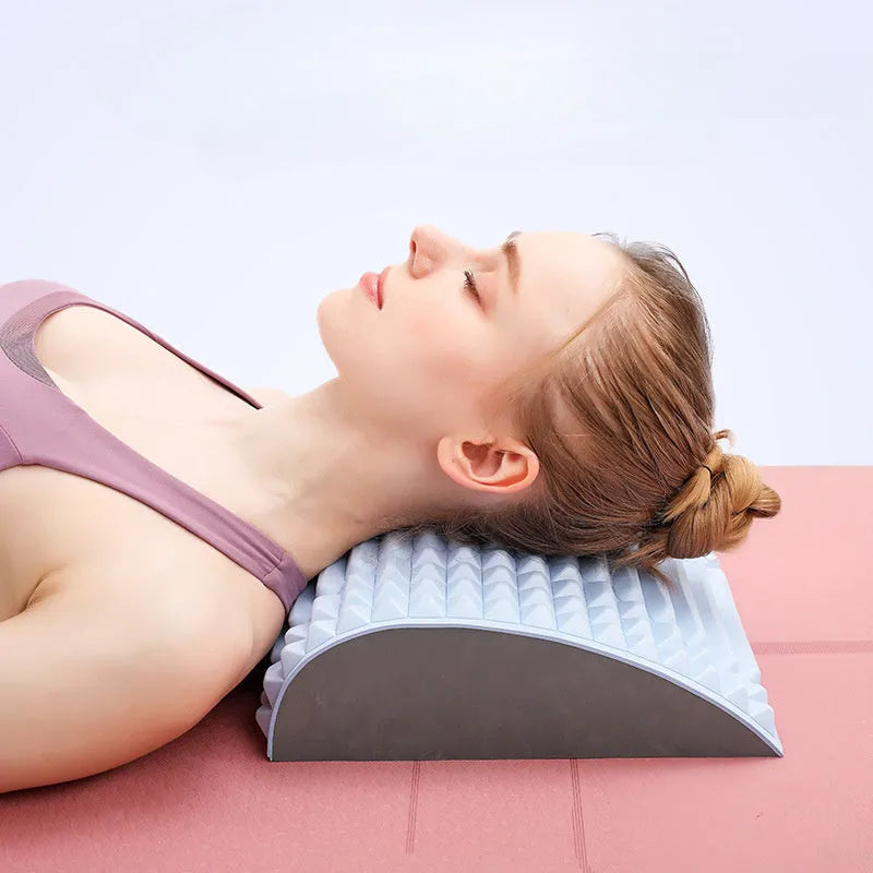 Blue back stretcher pillow for lumbar and neck support on a grey background.