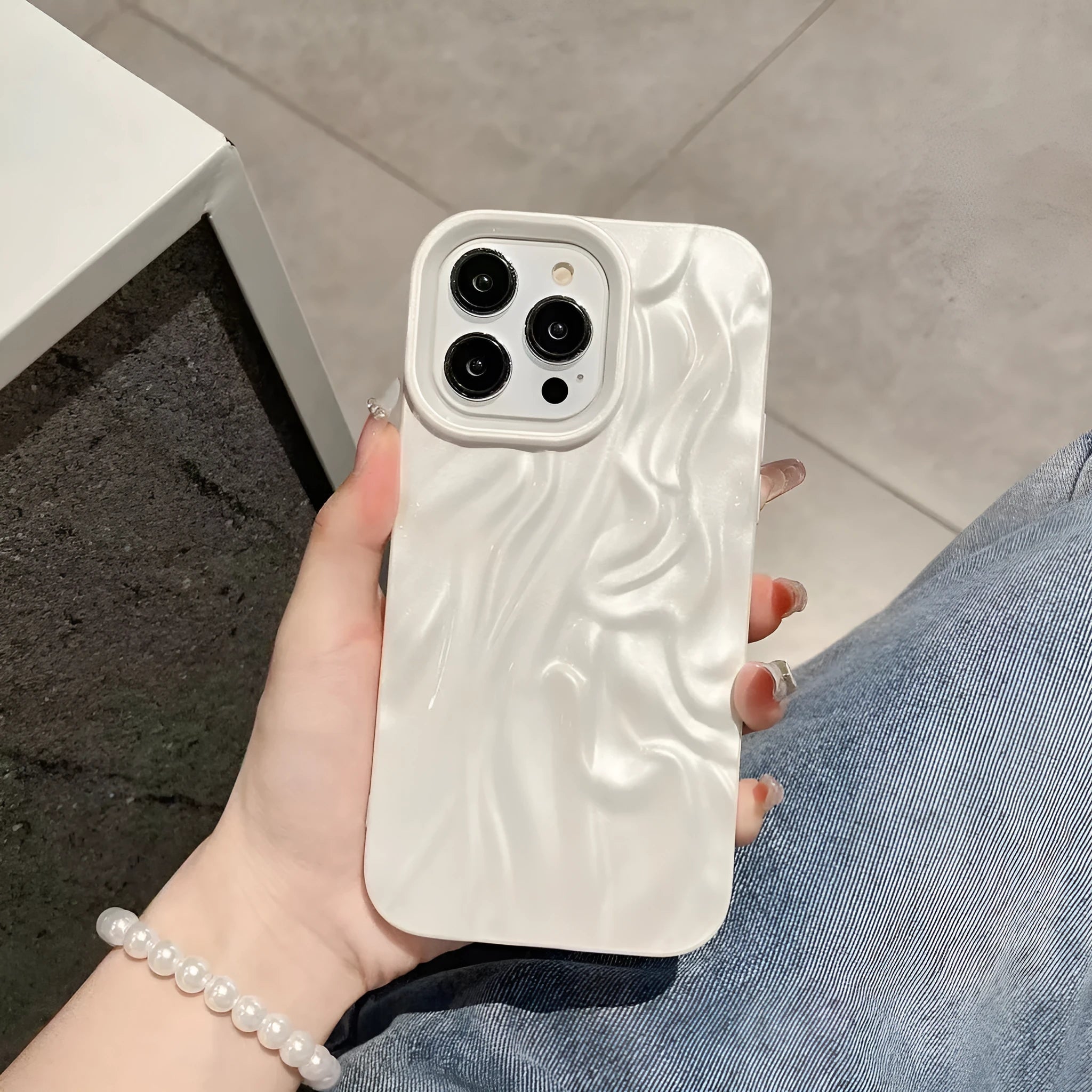 Solid colour water ripple texture silicone case for iPhone on a table.