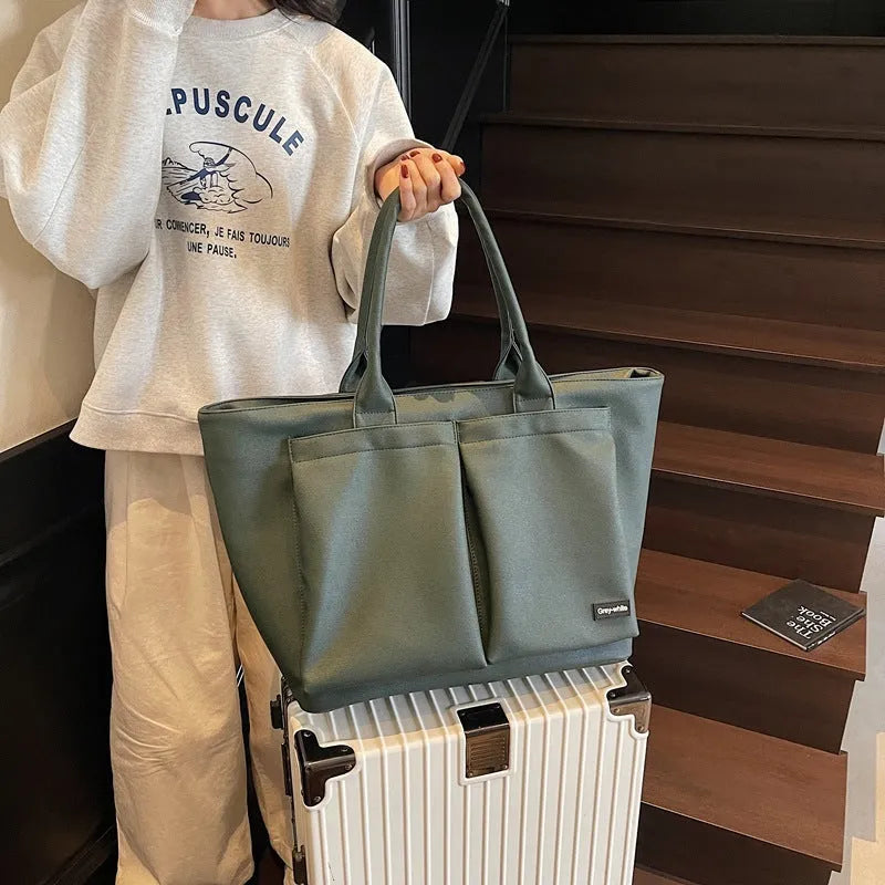 Lightweight expandable PU shoulder bag shown in solid green colour with ventilation panel