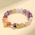 Handcrafted women's crystal bracelet with a lucky snake charm and red sealant flowers on a wrist.